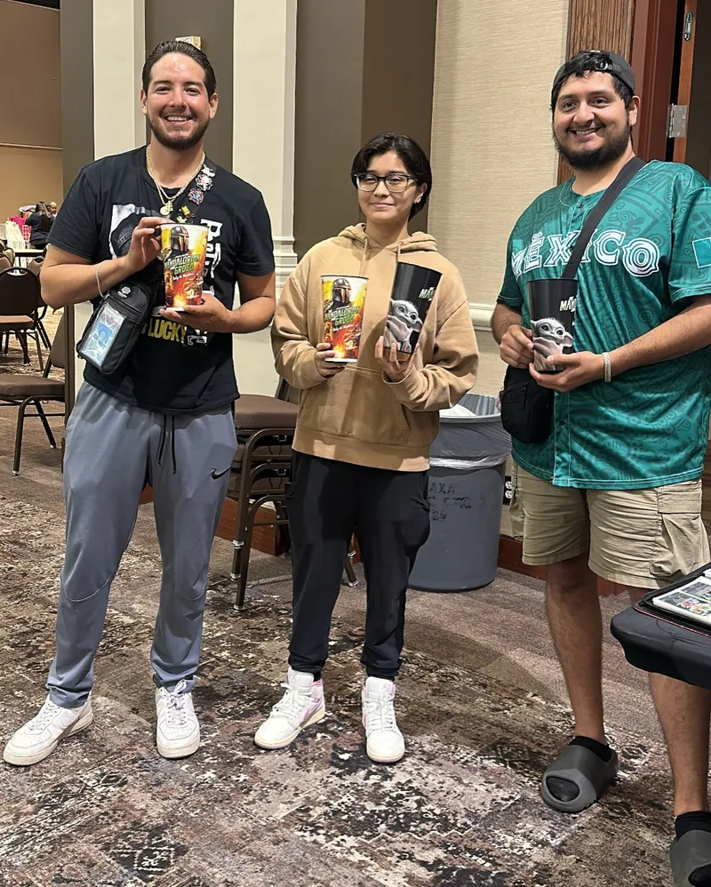 Three friends showing off what they picked up at the show
