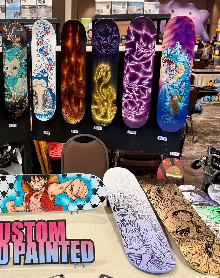 Custom hand-painted Pokémon skateboards for sale at a vendor booth